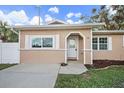 Inviting front entrance featuring a white door and trim, and a newly landscaped garden bed at 15 Tulane Rd, Venice, FL 34293