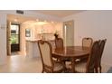 Bright kitchen with white cabinets, island, and dining area at 1716 Glenhouse Dr # 320, Sarasota, FL 34231