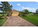 Attached two-car garage with brick-paved driveway and well-maintained landscaping; attractive curb appeal at 409 147Th Ne Ct, Bradenton, FL 34212