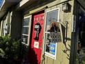 Inviting house exterior featuring a red front door and Halloween decorations at 617 12Th W Ave, Bradenton, FL 34205