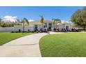 White two-story house with palm trees and circular driveway at 6817 Riverview Blvd, Bradenton, FL 34209