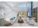 Spacious living room with a modern fireplace and pool view at 854 Macewen Dr, Osprey, FL 34229