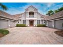 Large home with three-car garage and manicured landscaping at 854 Macewen Dr, Osprey, FL 34229