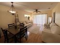 Living room with hardwood floors, and sliding doors to balcony at 19325 Water Oak Dr # 205, Port Charlotte, FL 33948