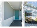 Welcoming front entry with teal door and white accent at 1105 58Th S St, Gulfport, FL 33707