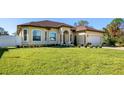 Well-maintained front yard with lush green grass and manicured landscaping leading to the home's facade at 1900 Colleen St, Sarasota, FL 34231