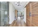 Light-filled entryway with wood flooring, barn door, and glass front door at 29205 Saddlebag Trl, Myakka City, FL 34251