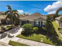 Single-Gathering house with a two-car garage, driveway, and manicured lawn at 805 Molly Cir, Sarasota, FL 34232