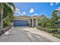 Single-Gathering home with a two-car garage and palm trees at 805 Molly Cir, Sarasota, FL 34232
