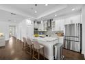 Bright, modern kitchen featuring a large island with marble countertops and stainless steel appliances at 805 Molly Cir, Sarasota, FL 34232