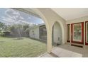 Enclosed porch with tiled flooring, offering views of the yard at 134 Da Vinci Dr, Nokomis, FL 34275