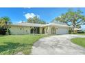 Front view of a single-story house with a curved driveway at 134 Da Vinci Dr, Nokomis, FL 34275