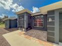 Covered front porch with tile flooring and screened entryway at 1661 Atwater Dr, North Port, FL 34288