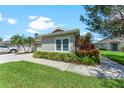 Well-maintained house with a landscaped lawn and driveway at 2412 Fairway Oaks Dr, Palmetto, FL 34221