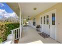 Inviting front porch with a decorative door, elegant lighting and a charming rug at 38603 Taylor Rd, Myakka City, FL 34251