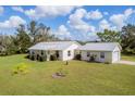 Aerial view of a house with metal roof and yard at 38603 Taylor Rd, Myakka City, FL 34251
