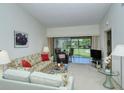 Living room with sofa, chairs, and view of patio at 4416 Weybridge # 90, Sarasota, FL 34235