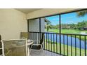 Screened patio with table and chairs overlooking golf course at 4416 Weybridge # 90, Sarasota, FL 34235