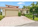 Luxury home with a brick driveway and landscaping at 4561 Murcia Blvd # 13, Sarasota, FL 34238