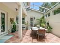 Covered patio with dining table and lush greenery at 4561 Murcia Blvd # 13, Sarasota, FL 34238