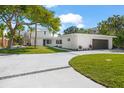 Modern, single Gathering home with attached garage and manicured lawn at 4915 Primrose Path, Sarasota, FL 34242