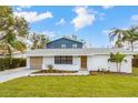Recently renovated home with white exterior, gray accents, and landscaping at 5321 13Th Avenue W Dr, Bradenton, FL 34209