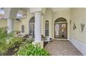 Elegant entryway with arched details and decorative columns at 7506 Eaton Ct, University Park, FL 34201