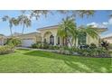 Single-story house with a two-car garage and tropical landscaping at 7506 Eaton Ct, University Park, FL 34201