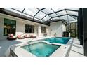 Resort-style pool and spa with covered patio and lounge chairs at 9260 Swaying Branch Rd, Sarasota, FL 34241