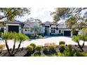 Beautiful home showcasing a well-manicured lawn, circular driveway, and grand entrance at 9260 Swaying Branch Rd, Sarasota, FL 34241