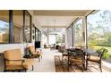 Covered patio with seating area and outdoor dining table at 9260 Swaying Branch Rd, Sarasota, FL 34241