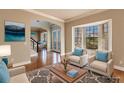 Virtually staged living room with hardwood floors and comfy seating at 14106 18Th E Pl, Bradenton, FL 34212