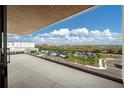 Private balcony with glass railings offering scenic views at 1591 Gulf Of Mexico Dr # 413, Longboat Key, FL 34228