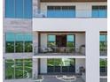 Spacious balcony with glass railings and outdoor grill at 1591 Gulf Of Mexico Drive # 311, Longboat Key, FL 34228