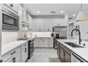 Modern kitchen with white cabinets and stainless steel appliances at 16247 Hidden Oak Loop, Bradenton, FL 34211