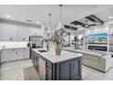 Open concept kitchen with island, stainless steel appliances and breakfast bar at 16247 Hidden Oak Loop, Bradenton, FL 34211
