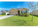 Tan house with blue shutters and a two-car garage at 2201 Tally Breeze Way, Bradenton, FL 34208