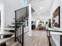 Modern entryway with a floating console table and staircase at 2415 Floyd St, Sarasota, FL 34239