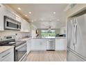 Bright, modern kitchen featuring stainless steel appliances and open layout to living area at 3660 Ironwood Cir # 101M, Bradenton, FL 34209