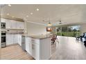 Well-lit kitchen flows into the dining area with stainless steel appliances and granite countertops at 3660 Ironwood Cir # 101M, Bradenton, FL 34209