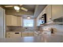 White kitchen with gray countertops and appliances at 4452 Garnet Dr # 205, New Port Richey, FL 34652