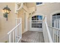 Townhouse entrance with steps, railing, and a light fixture at 4517 Streamside Ct # 1905, Sarasota, FL 34238