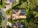 Aerial view of single-Gathering home with pool and landscaped yard at 4867 Carrington Cir, Sarasota, FL 34243