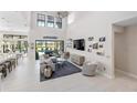 Open living space with high ceilings, pool views, and a large sectional sofa at 7634 Windy Hill Cv, Bradenton, FL 34202