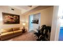 Bright sitting area with a sofa and access to kitchen at 99 Vivante Blvd # 99315, Punta Gorda, FL 33950