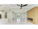 Open concept living room with high ceilings, recessed lighting, and a modern fireplace at 1010 Acadia Rd, Venice, FL 34293