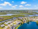 Aerial view featuring a waterfront home with an enclosed pool, and waterway views at 1228 50Th E St, Bradenton, FL 34208