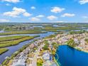 Aerial view highlighting waterfront property with lush landscaping and serene lake views at 1228 50Th E St, Bradenton, FL 34208