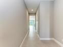 Spacious hallway with tile flooring leading to the living area at 12389 Cedar Pass Trl, Parrish, FL 34219