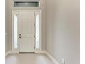 Bright and airy entryway with a classic white door and sidelights at 12389 Cedar Pass Trl, Parrish, FL 34219